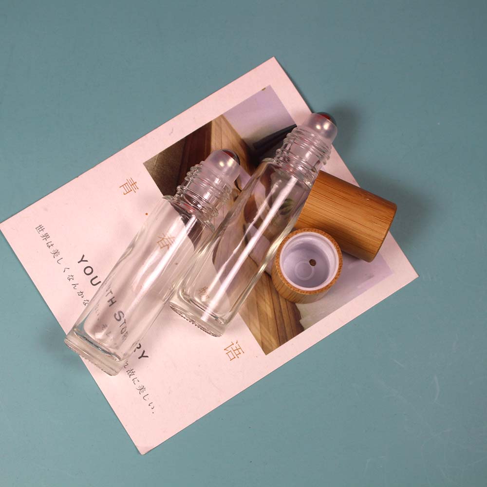 Empty bamboo cap glass roll on bottle with stainless roller ball