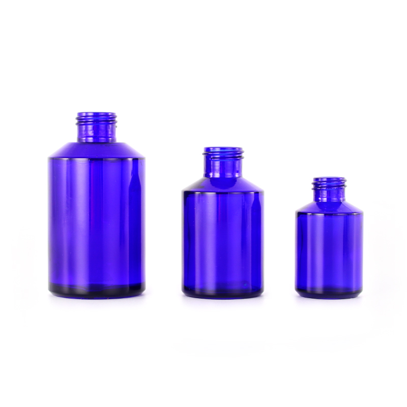 Empty cobalt blue glass cosmetic lotion pump bottles