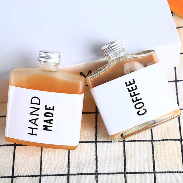 Empty flat square clear or frosted glass coffee wine beverage bottle with aluminum cover