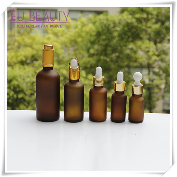 Empty frosted amber glass dropper bottle