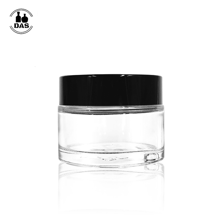 Empty round 2oz glass cosmetic jar with plastic lid