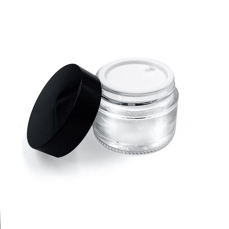 Empty round 2oz glass cosmetic jar with plastic lid