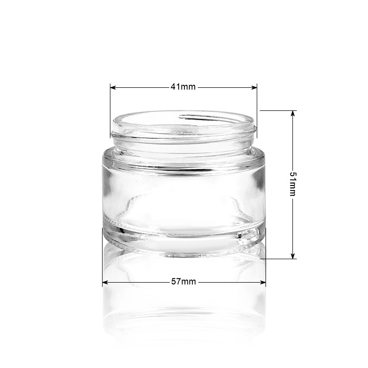 Empty round 2oz glass cosmetic jar with plastic lid