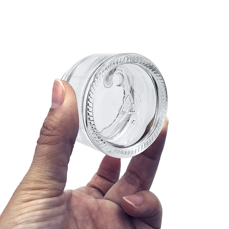 Empty round 2oz glass cosmetic jar with plastic lid