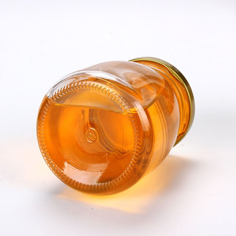 Factory direct sale glass patch bird's nest with lid empty honey bottle
