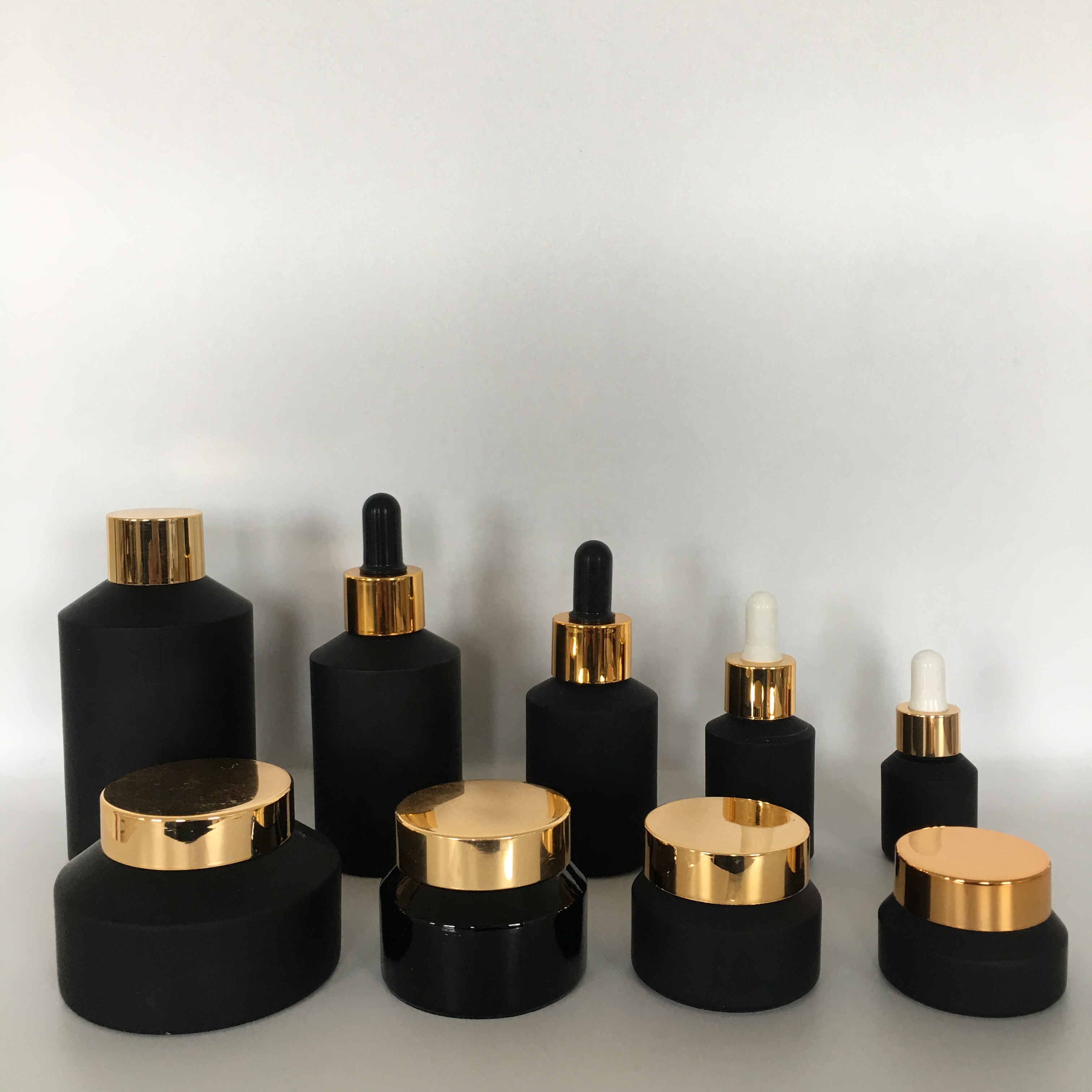 Factory hot sale cosmetic bottle jar packaging series frosted black slant shoulder glass lotion bottle with gold lid