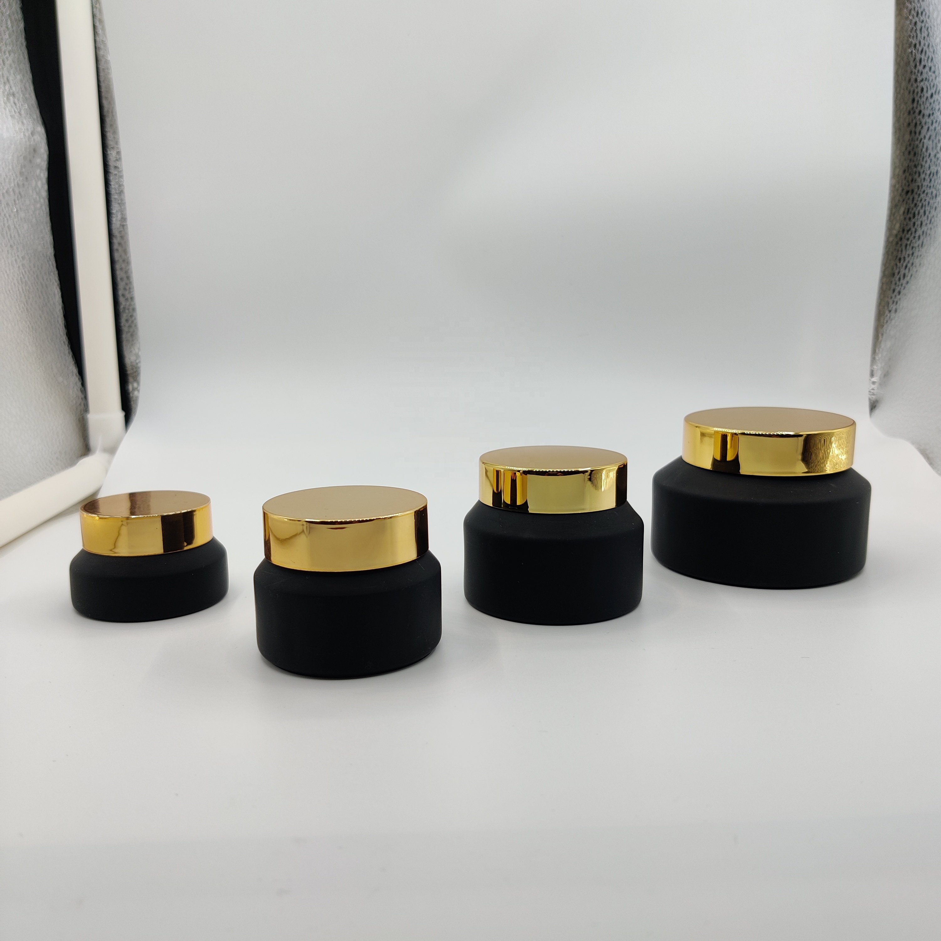 Factory hot sale cosmetic bottle jar packaging series frosted black slant shoulder glass lotion bottle with gold lid