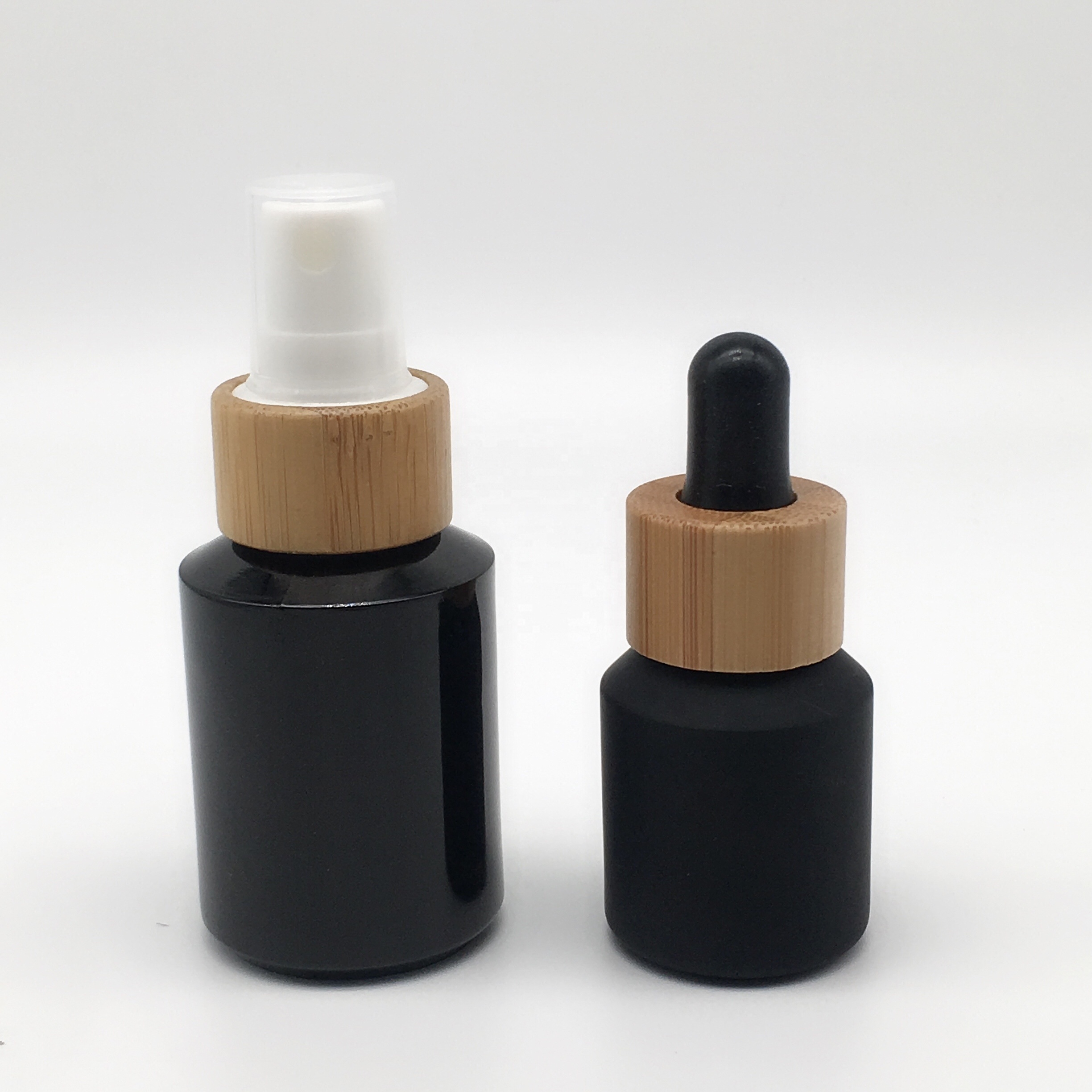 Factory hot sell cosmetic packaging frosted black glass bottle and jar with bamboo lid