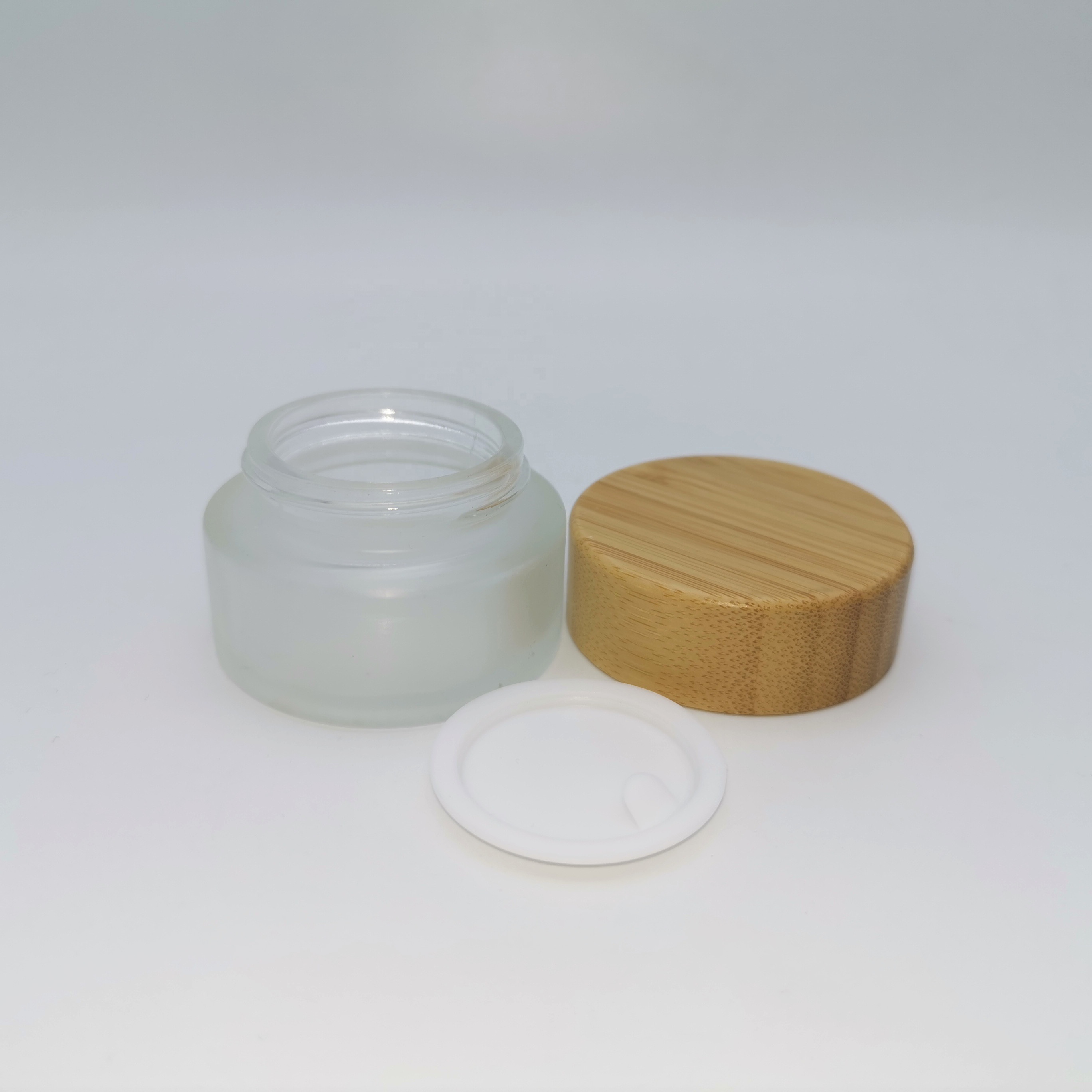 Factory price cosmetic containers frosted cream glass jar with bamboo lid