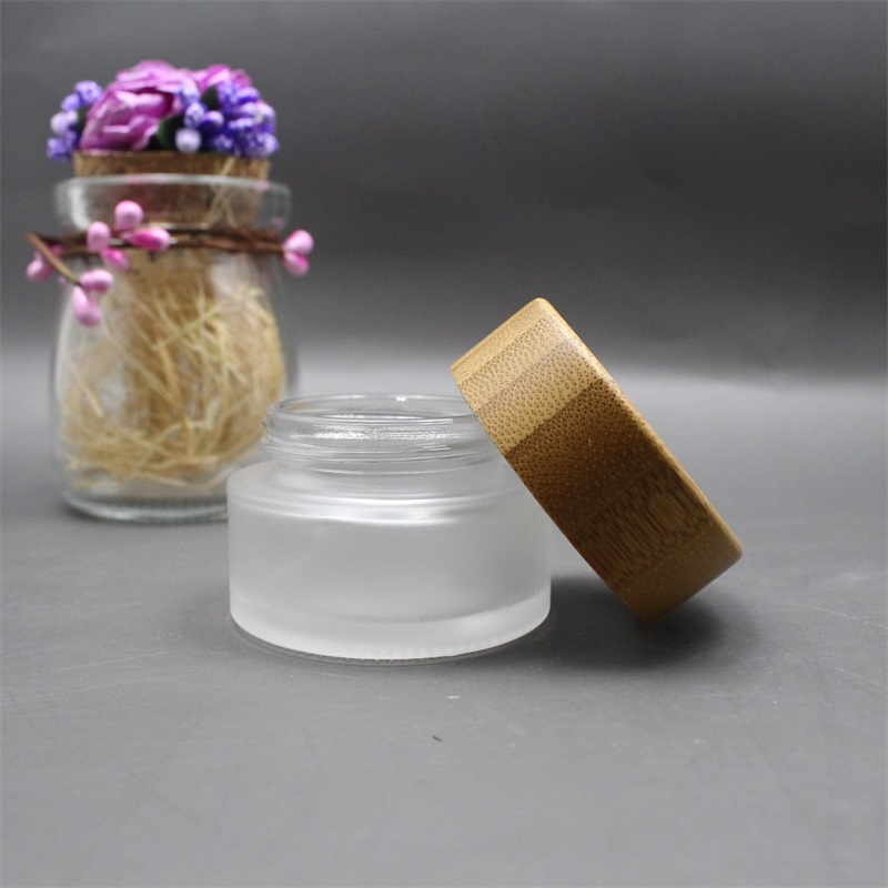 Factory wholesale cosmetic bamboo jar clear frosted glass cream jar 100% nature bamboo wooden lid envases