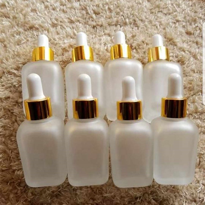 Fancy square 15ml 20ml 30ml 50ml 100ml 30 ml clear frosted clear perfume glass dropper bottle with gold hollow caps