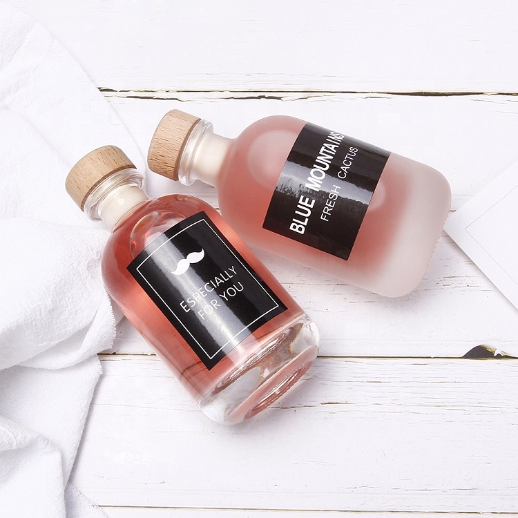 Food grade clear frosted round glass bottle with cork stopper for juice beverage liquor packaging
