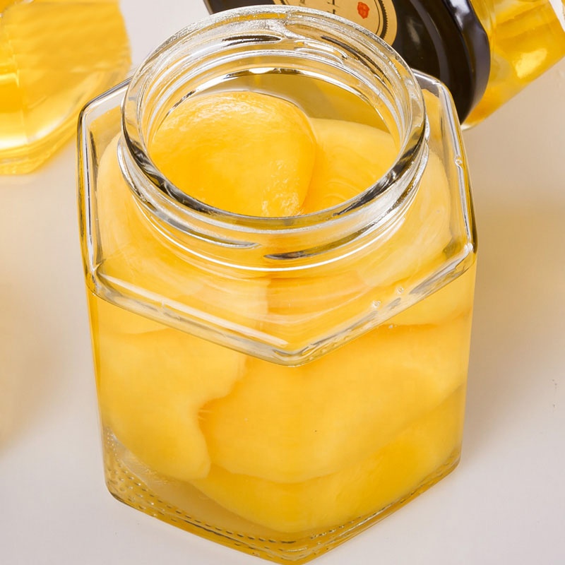 Free sample cheap hexagon honey jars, hexagon glass jar 50ml 180ml 380ml 500ml with black lids food jar