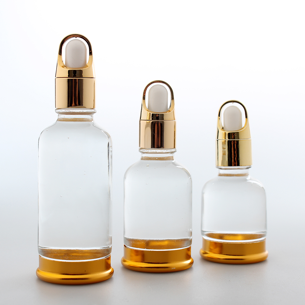 Glass essential oil dropper bottle with gold basket dropper