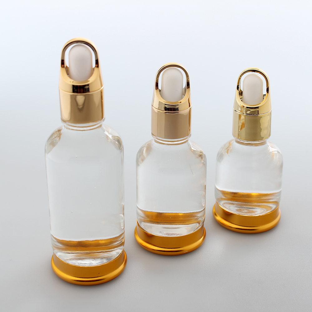 Glass essential oil dropper bottle with gold basket dropper