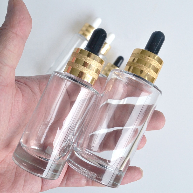 HOT sale luxury flat shoulder Cosmetics 30ml 50ml 60ml 100ml clear essential oil glass dropper bottle with gold cap