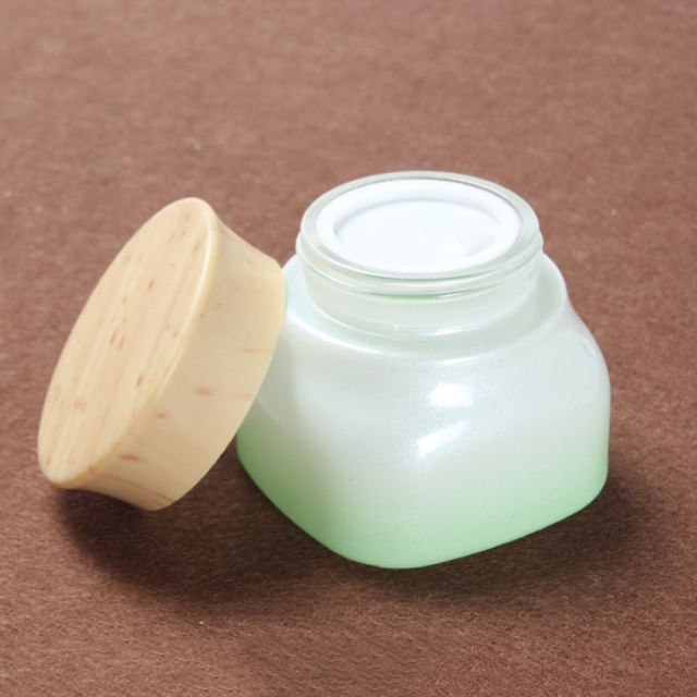 Hengjian 50g graduated green white glass for cosmetic packaging skin care face eye cream jar with plastic wood pattern cap