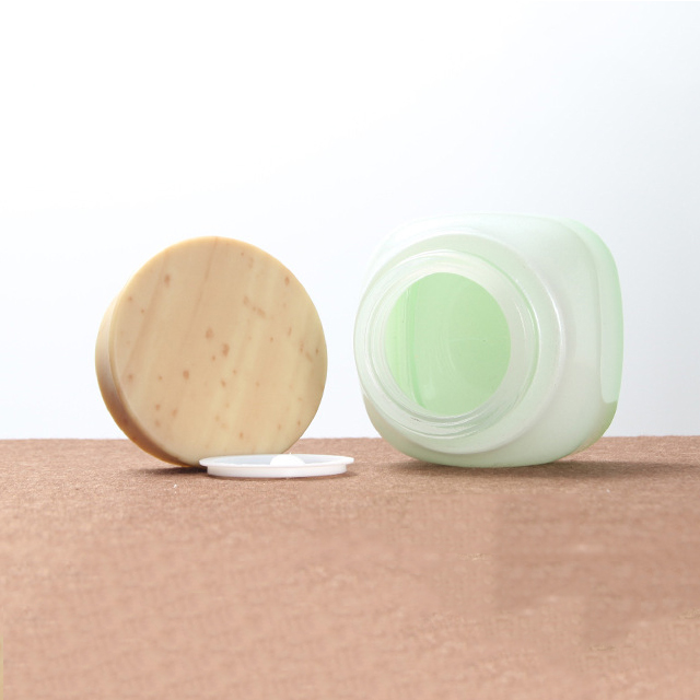 Hengjian 50g graduated green white glass for cosmetic packaging skin care face eye cream jar with plastic wood pattern cap