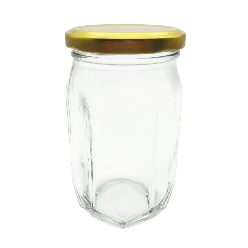Hexagon glass storage honey jar with screw metal lid and irregular surface