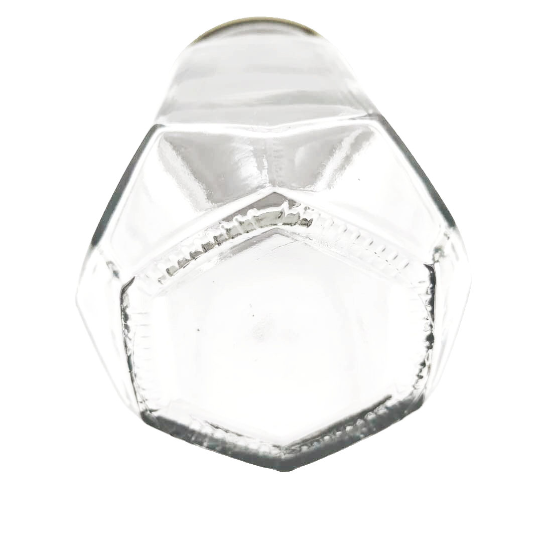 Hexagon glass storage honey jar with screw metal lid and irregular surface
