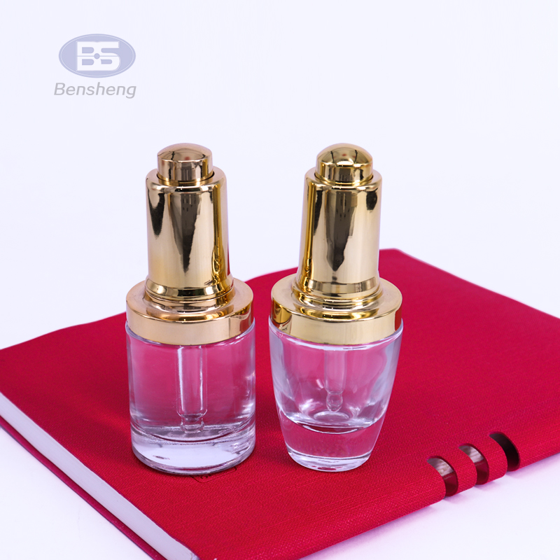 High quality round clear 30ml essential oil bottle gold silver glass press pump dropper bottle serum bottles