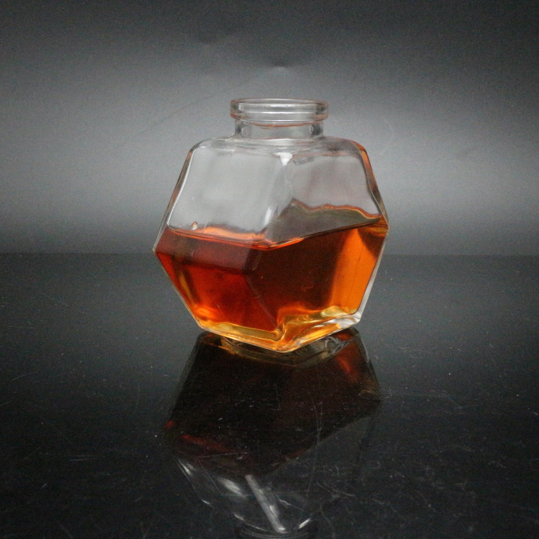 Honey glass jar with wooden lid and spoon