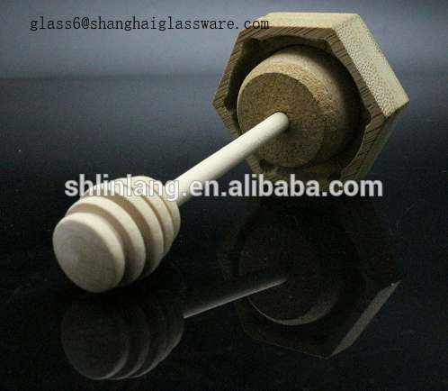 Honey glass jar with wooden lid and spoon