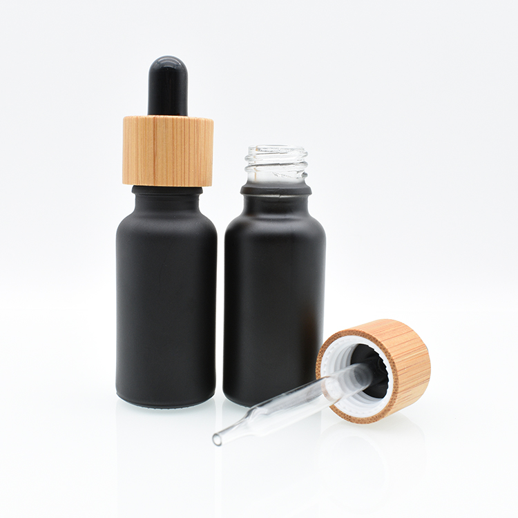 Hot sale 5ml 10ml 15ml 20ml 30ml 50ml 100ml bamboo cap lid essential oil matte black frosted glass bamboo dropper bottle