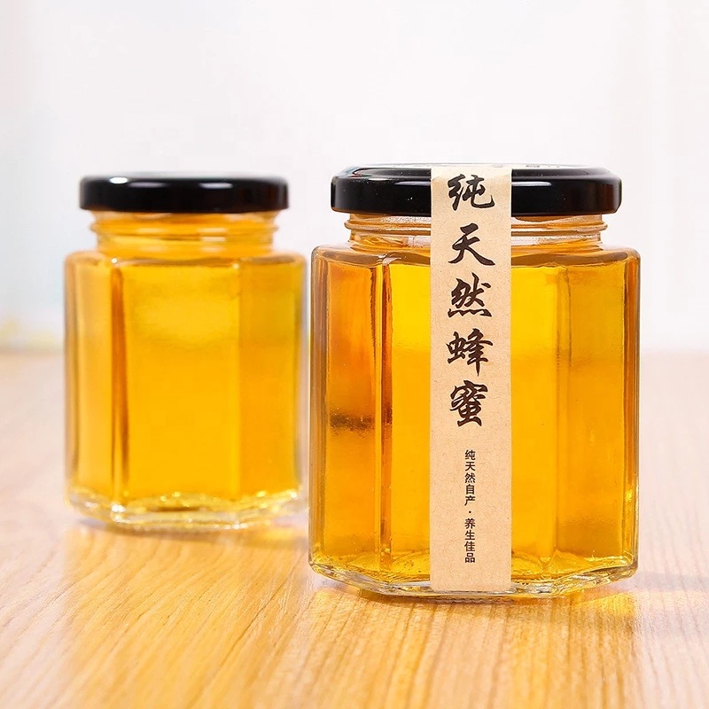 Hot sale empty small to large glass honey jar new design honey packing hexaganal storage jar for sale