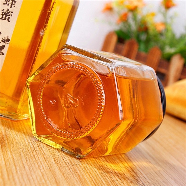 Hot sale empty small to large glass honey jar new design honey packing hexaganal storage jar for sale