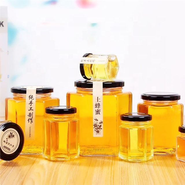 Hot sale empty small to large glass honey jar new design honey packing hexaganal storage jar for sale