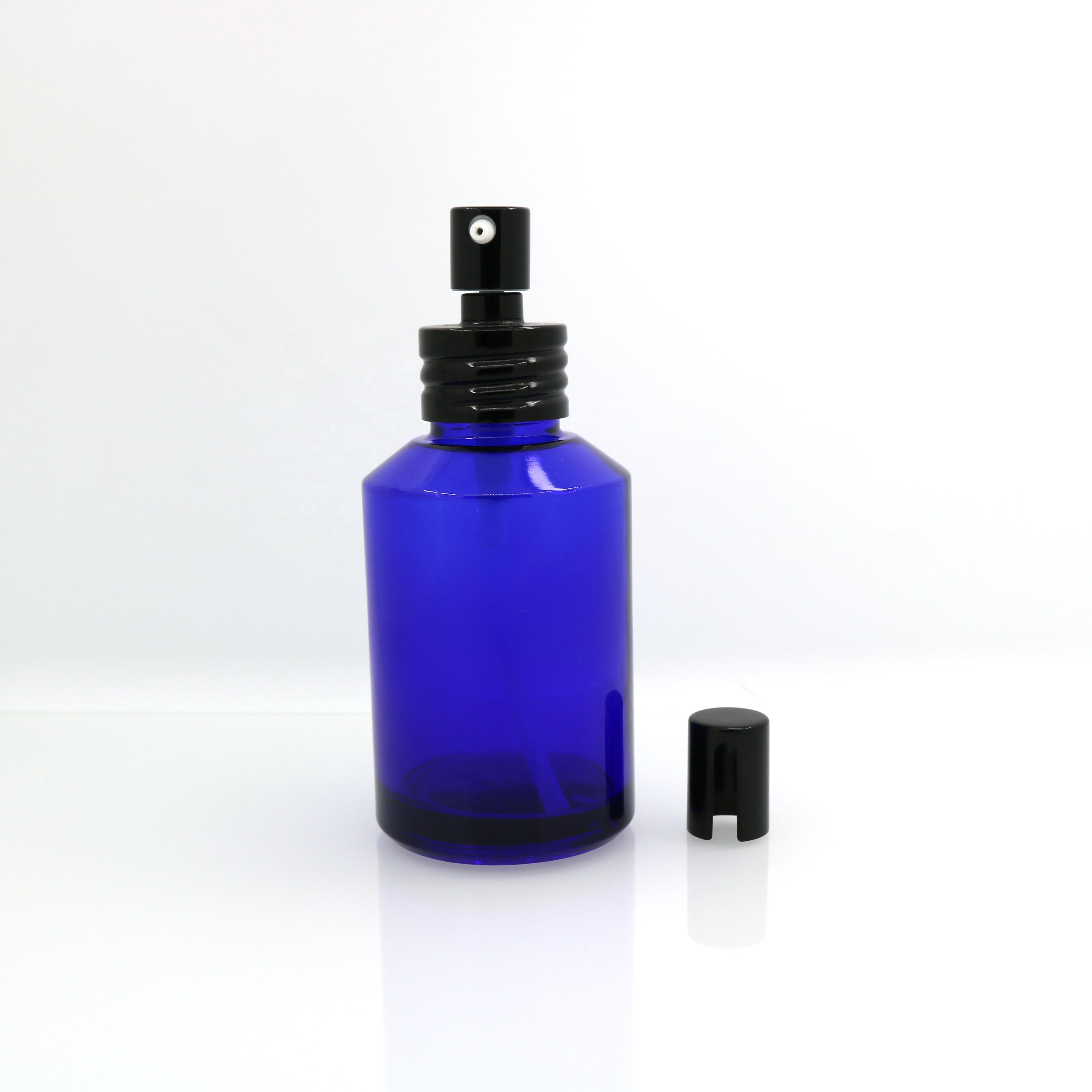 Hot-sale in Stock 1oz 2oz 4oz blue glass spray pump bottle with black metal top for natural cosmetics