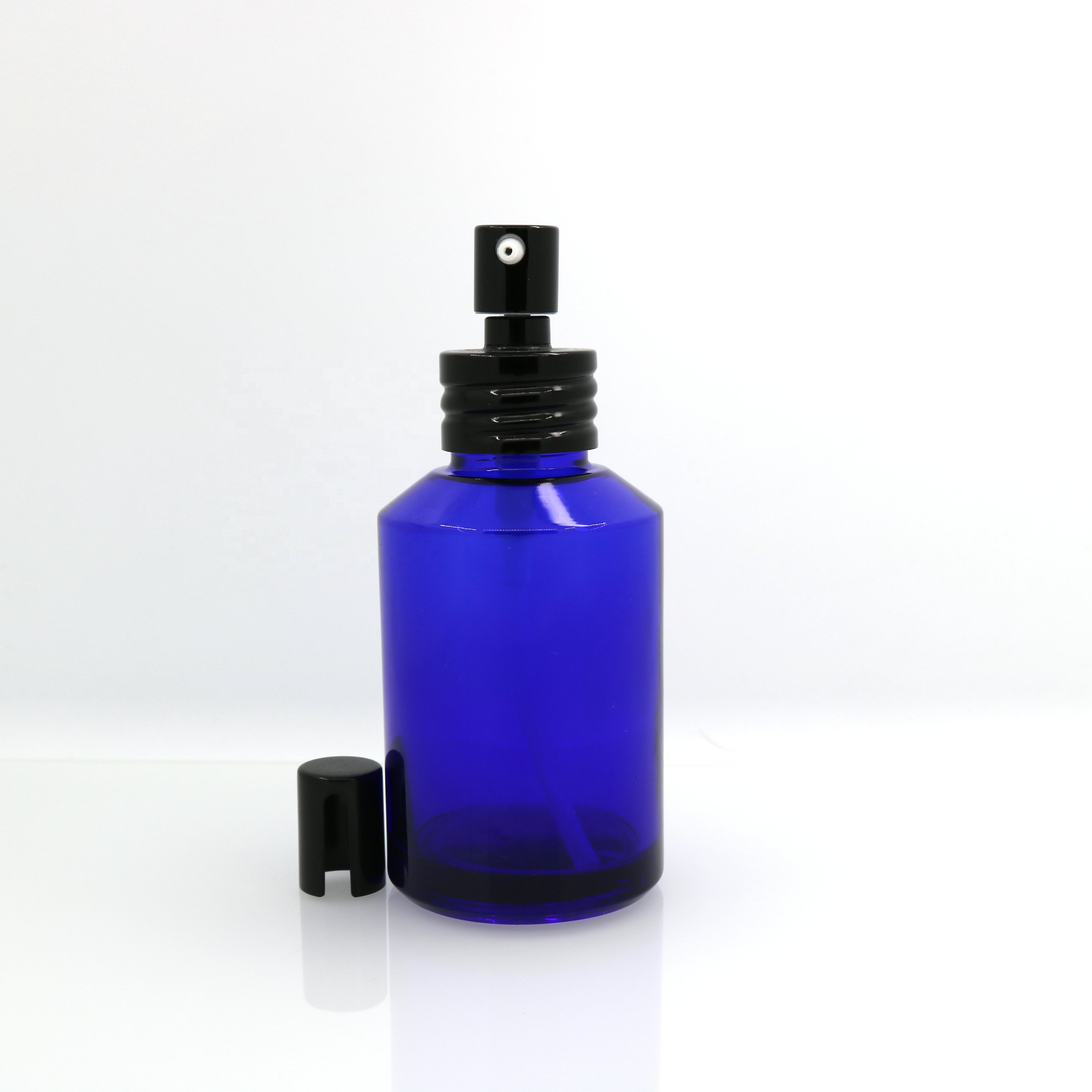 Hot-sale in Stock 1oz 2oz 4oz blue glass spray pump bottle with black metal top for natural cosmetics