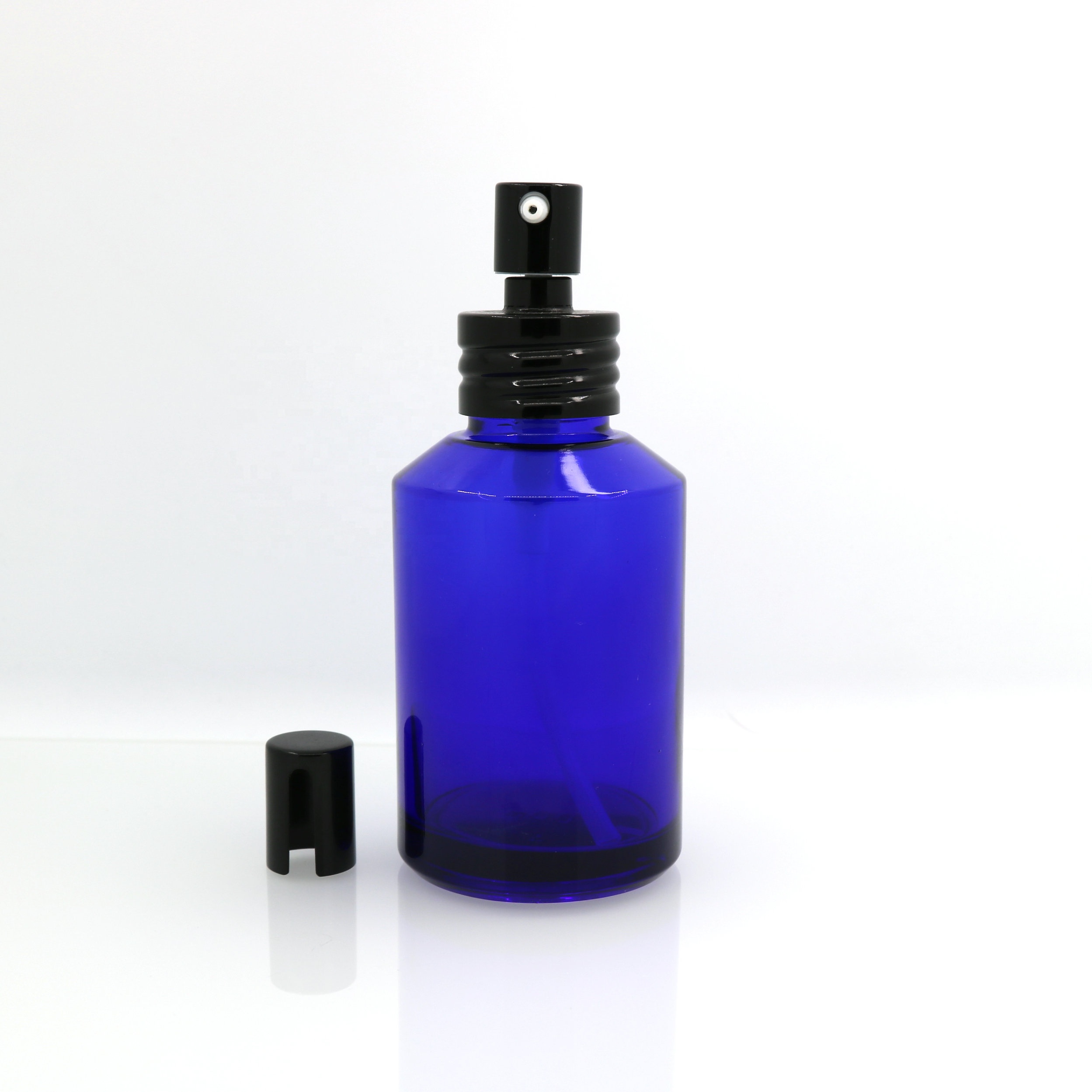 Hot-sale in Stock 1oz 2oz 4oz blue glass spray pump bottle with black metal top for natural cosmetics