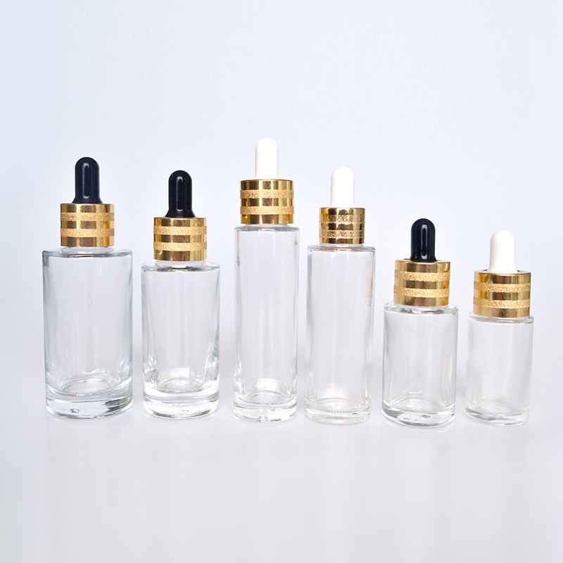 Hot sale luxury 30ml 50ml 60ml 100ml clear flat shoulder cosmetic beauty essential oil glass dropper bottle with gold cap