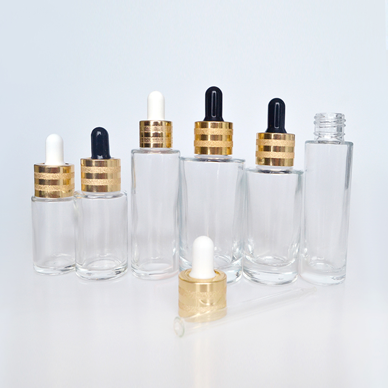 Hot sale luxury 30ml 50ml 60ml 100ml clear flat shoulder cosmetic beauty essential oil glass dropper bottle with gold cap