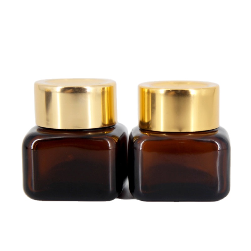 Hot sales cosmetic bottles mini square clear or brown glass cream jars lotion box with gold lids