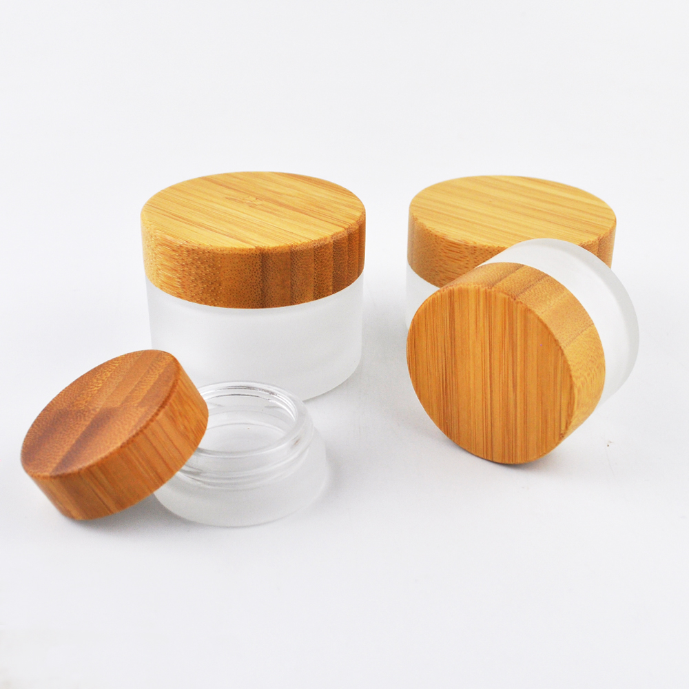 Hot sell 1oz 2oz clear frost glass container cosmetic empty face cream jar with wooden screw cap