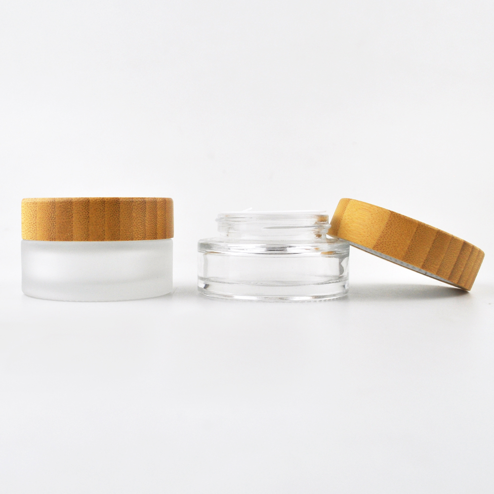 Hot sell 1oz 2oz clear frost glass container cosmetic empty face cream jar with wooden screw cap