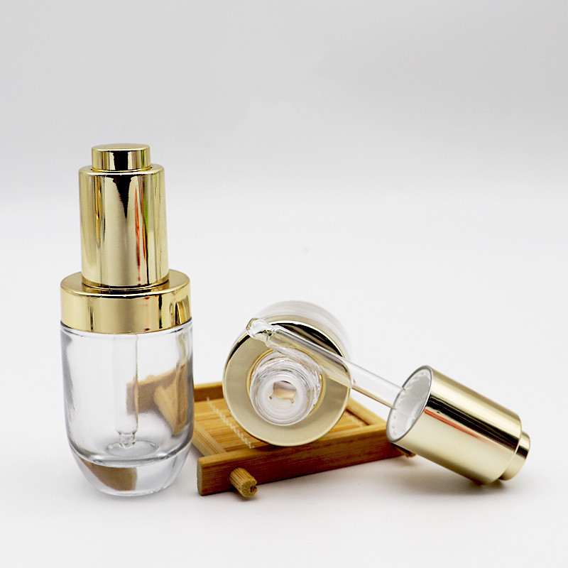 Hot sell empty transparent press dropper bottle 30ml push button serum bottle glass with golden cap pipette