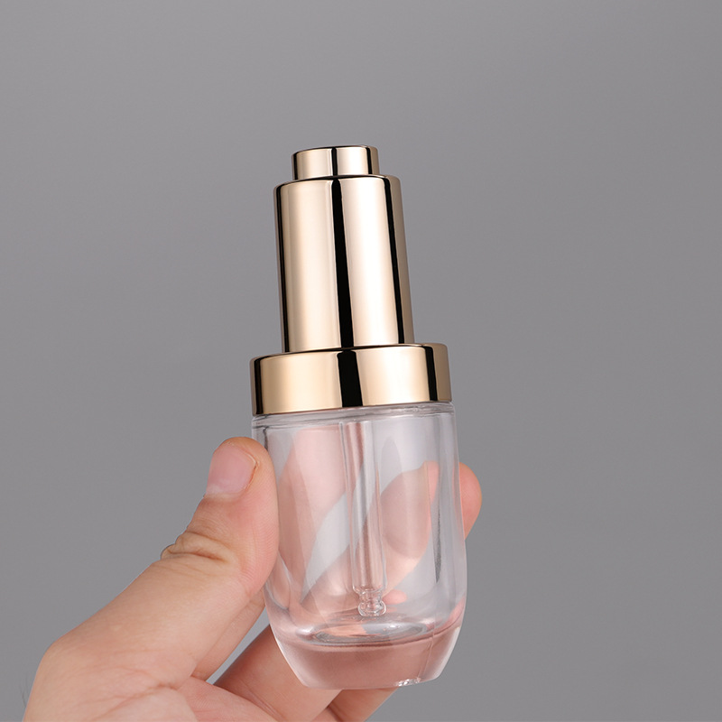 Hot sell empty transparent press dropper bottle 30ml push button serum bottle glass with golden cap pipette