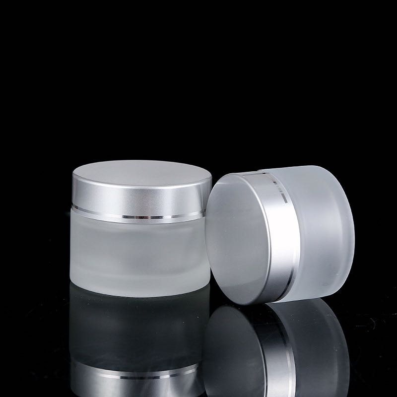 Hot sell fashionable fancy cosmetics 100g clear frosted glass cream jar with silver lids