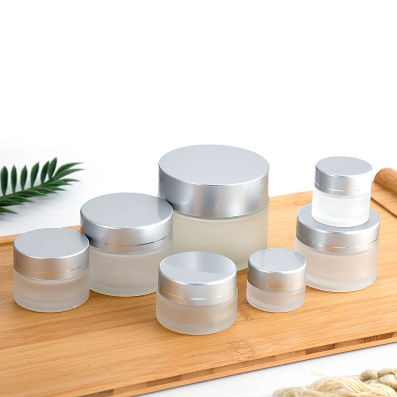 Hot sell fashionable fancy cosmetics 100g clear frosted glass cream jar with silver lids