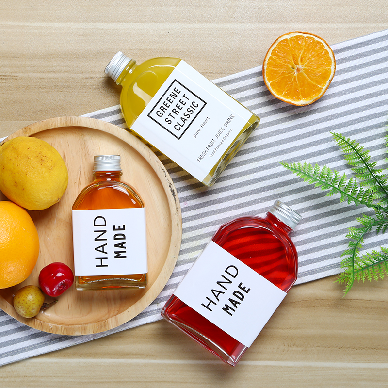 Hot selling 100ml 200ml 250ml 350ml 500ml flat transparent glass juice drink bottle with lid