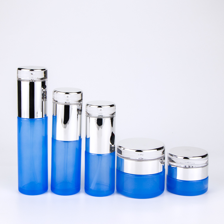 Hotsale Light Blue Transparent Glass Cosmetic Bottle and Jar with Pump and Luxury Water Drop Cap