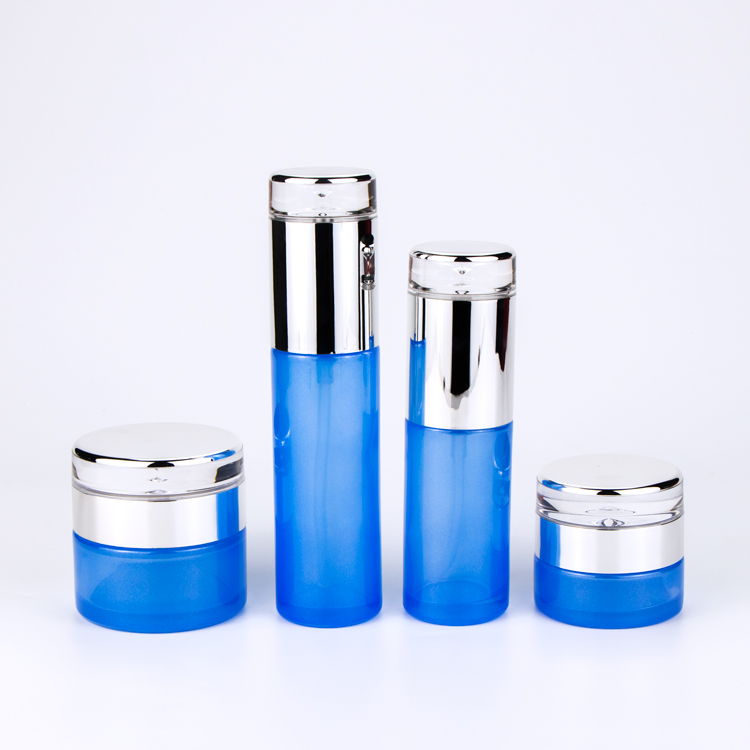 Hotsale Light Blue Transparent Glass Cosmetic Bottle and Jar with Pump and Luxury Water Drop Cap