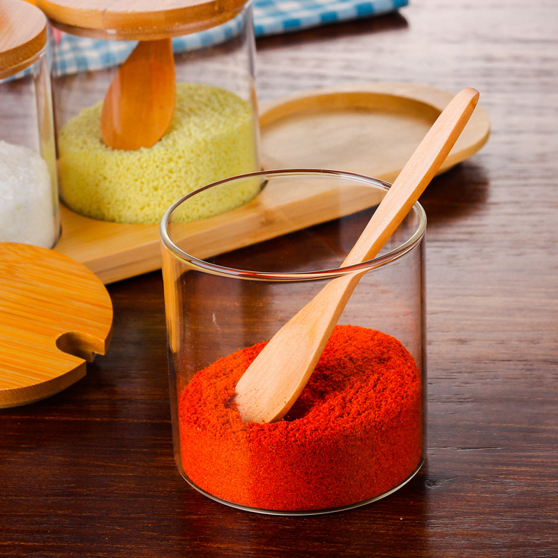 Kitchen condiment jar set with rounded bottom, wooden spoon, bamboo cover