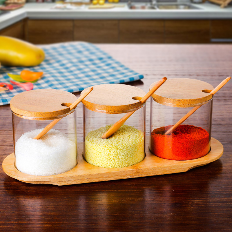 Kitchen condiment jar set with rounded bottom, wooden spoon, bamboo cover