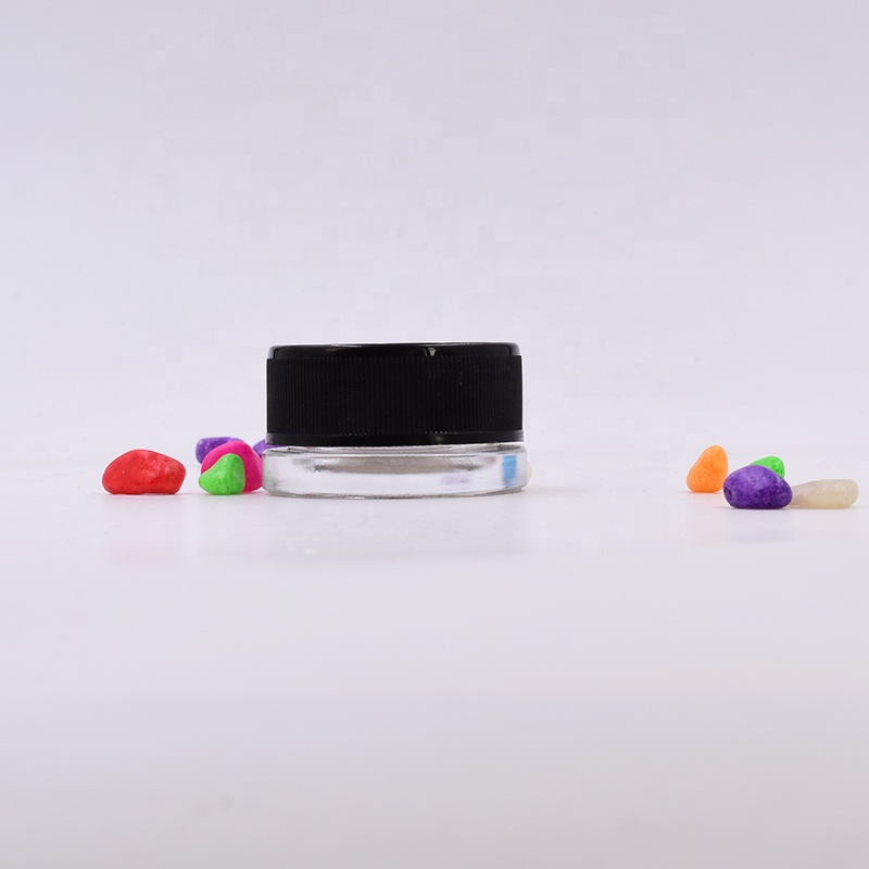 Lovely 9 ml clear round small straight side eye cream cosmetic packing glass jar with black plastic child proof lid.