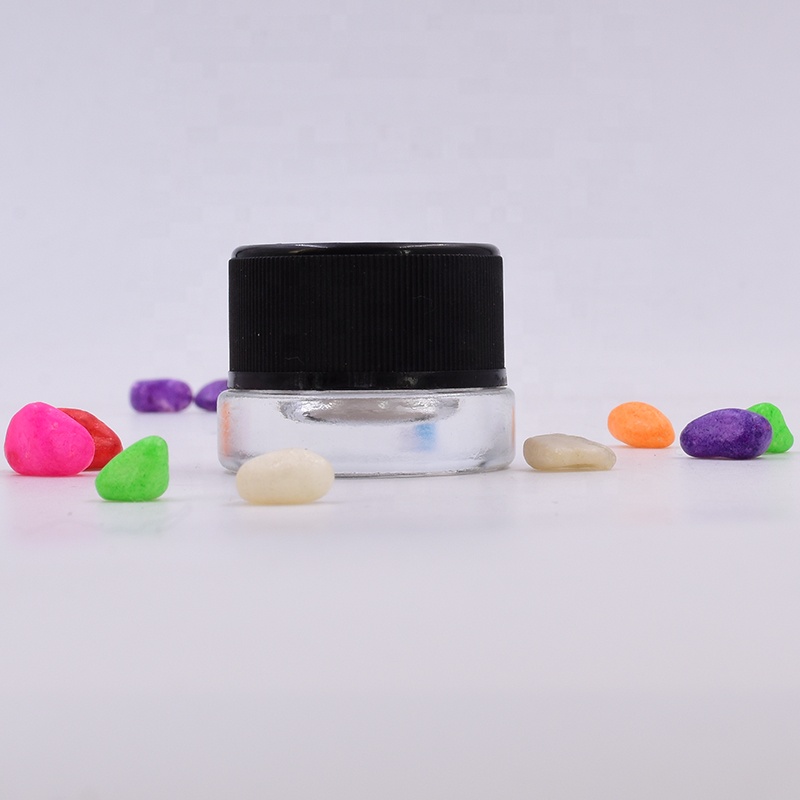 Lovely 9 ml clear round small straight side eye cream cosmetic packing glass jar with black plastic child proof lid.